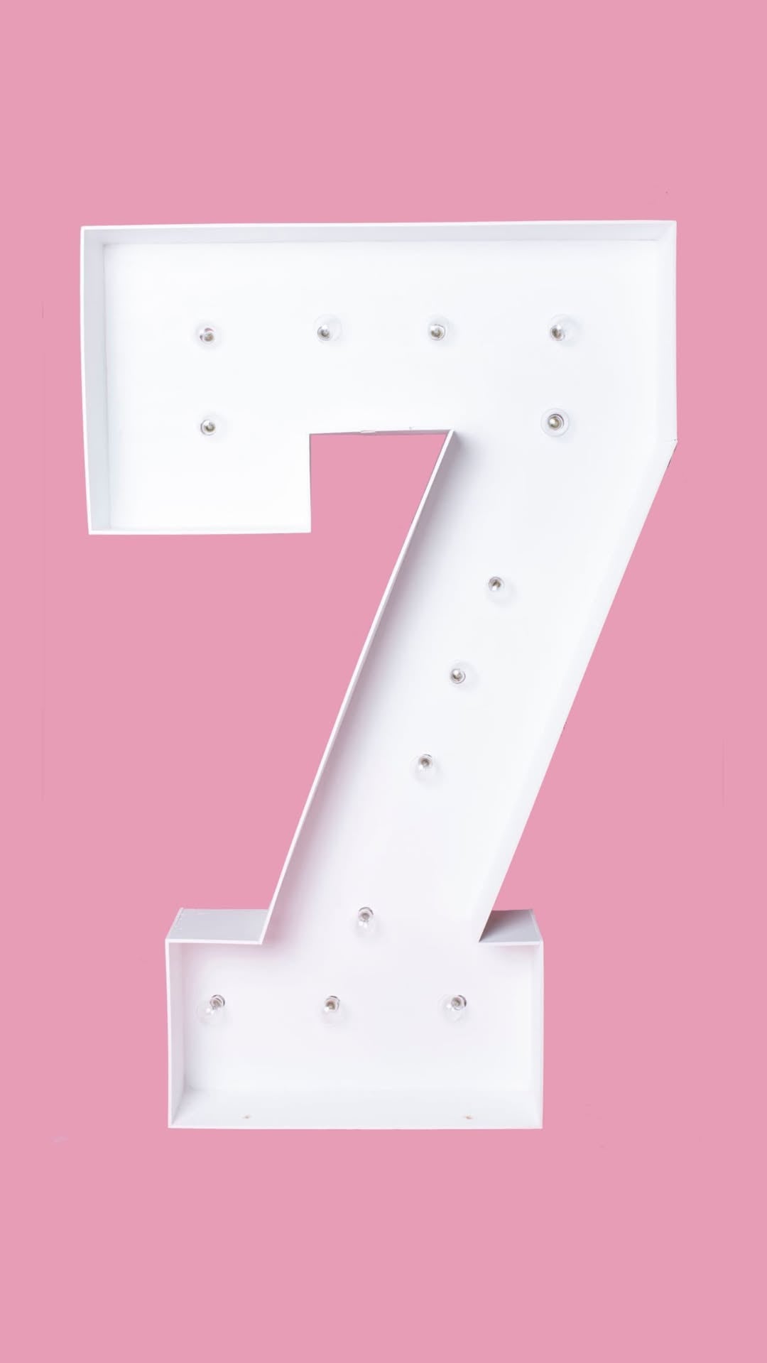 light up number 7 marquee with pink background